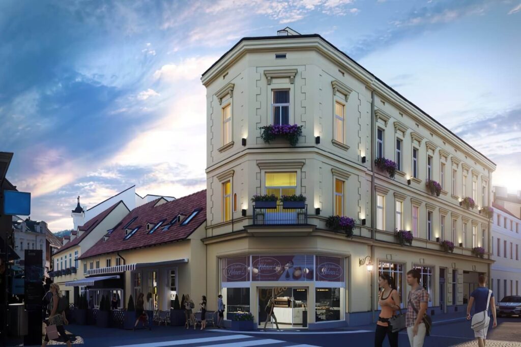 Noční 3D vizualizace moderního bytového domu s prosvětlenými výlohami obchodů v přízemí a osvětlenou ulicí.